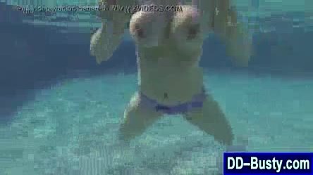 Big tits blonde swims topless