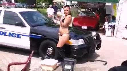 Bikini carwash strip dance near police car